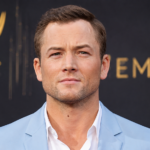 Taron Egerton hair in a classic side part hairstyle at an award show